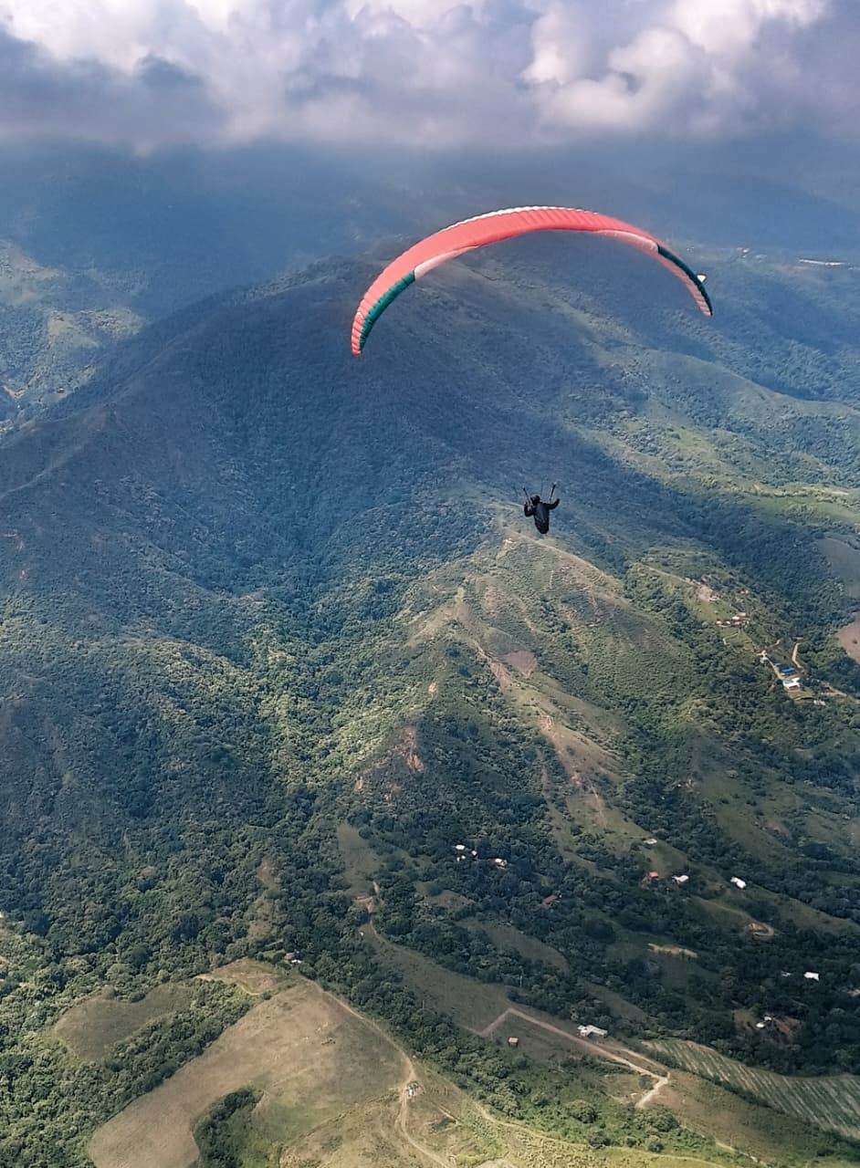Paraglider above the green mountains of El Cerrito
